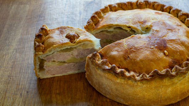 Savory Pork Pie Delights on Rustic Wooden Table side wiev, slice