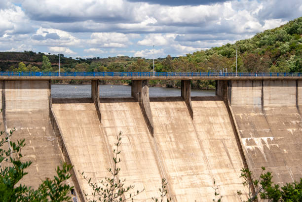 istock Overflow of a reservoir dam under a cloudy sky. 1488023177
