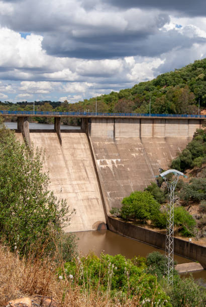 istock Vertical image of a reservoir dam under a cloudy sky. 1488023178