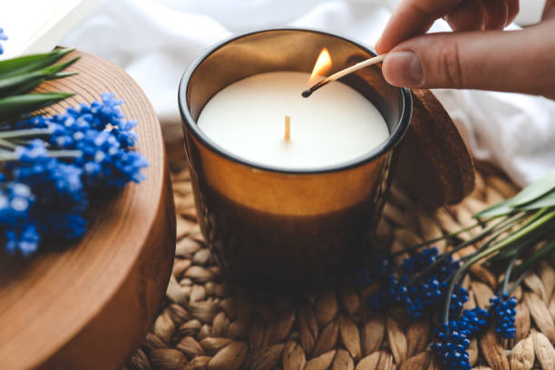 istock Match in hand lights a candle, atmospheric photo 1488024968