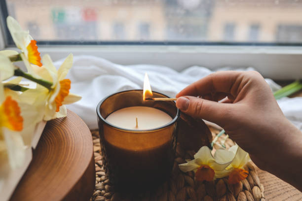 istock Match in hand lights a candle, atmospheric photo 1488024969