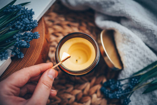 istock Match in hand lights a candle, atmospheric photo 1488024977