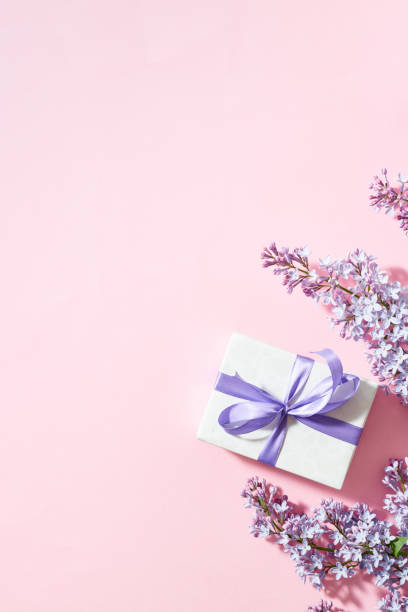 istock Lilac branches and gift box on a pink background 1488025093
