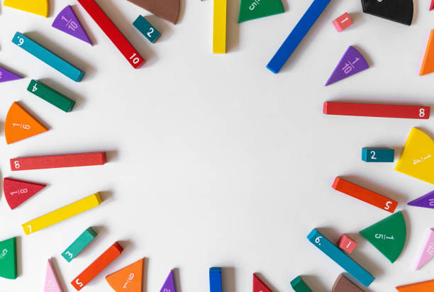 Math fractions on white background. Interesting math for kids. Education, back to school concept. Geometry and mathematics materials. Close up