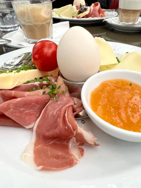 istock boiled egg and bacon ham or Italian prosciutto on plate for breakfast. 1488027154