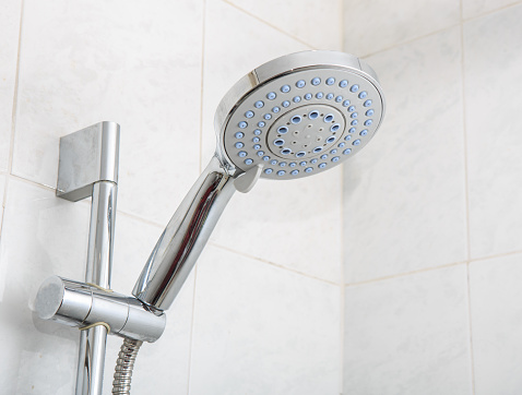 Large shower head on a bracket on the wall close-up