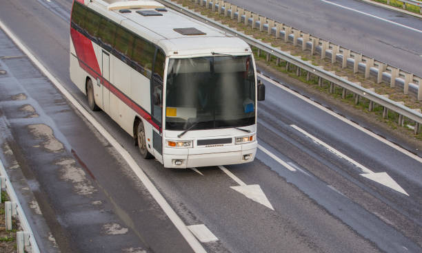 istock Bus moves along the suburban highway 1488033292