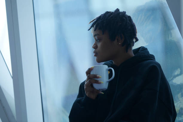 istock Black girl drinking coffee indoors 1488033432