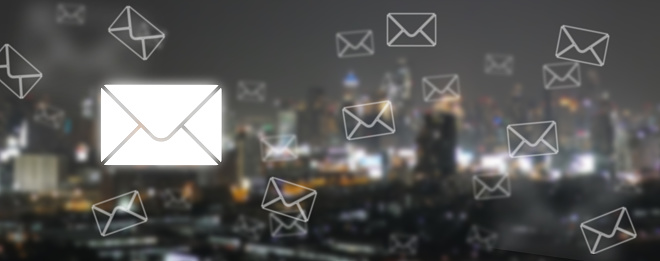 Concept of Email Communication and Connectivity: Postal Envelopes and Emails on Defocused Cityscape Background