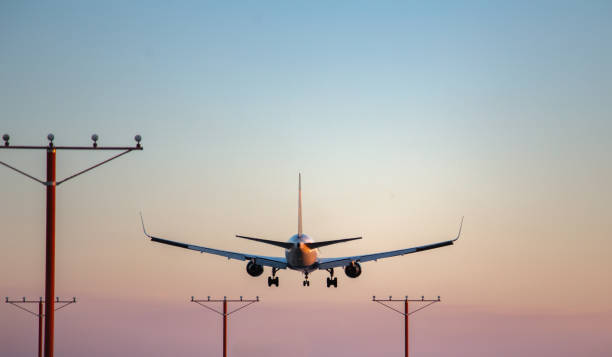 istock Airplane landing at sunset, sunsets background, travel background 1488038641