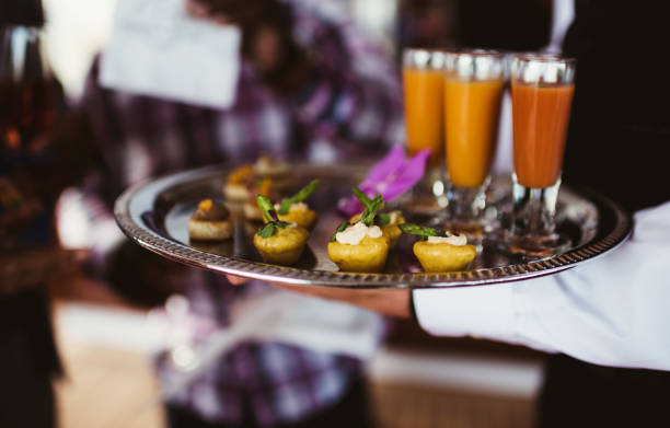 istock Waiter with tray of appetizers and drinks 1488042159