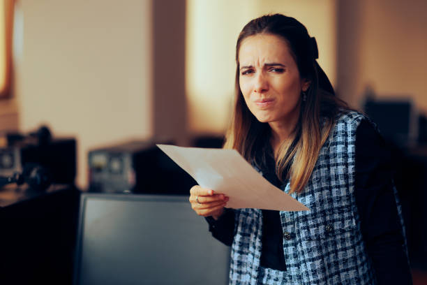 istock Woman Having Difficulties Reading a Contract in Fine Print 1488046675