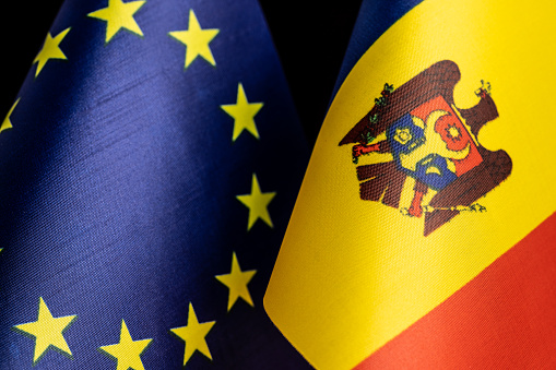 Close up flags of European Union and Republic of Moldova, a concept of Moldova being a candidate to join the EU. European Political Community (EPC) will meet in Chisinau.