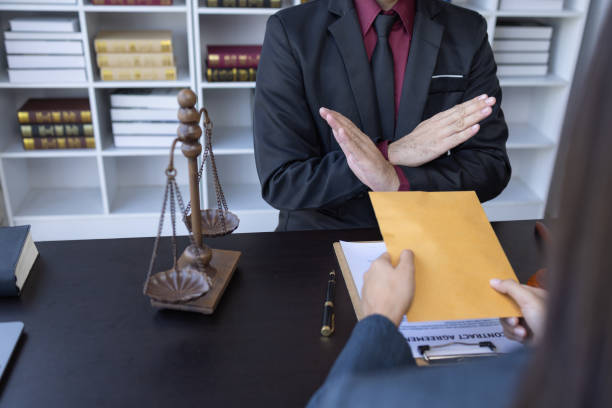 Corruption and Bribery,Businessman manager refusing receive money from Business man passing money dollar bills to deal contract.Corruption and anti bribery concept.