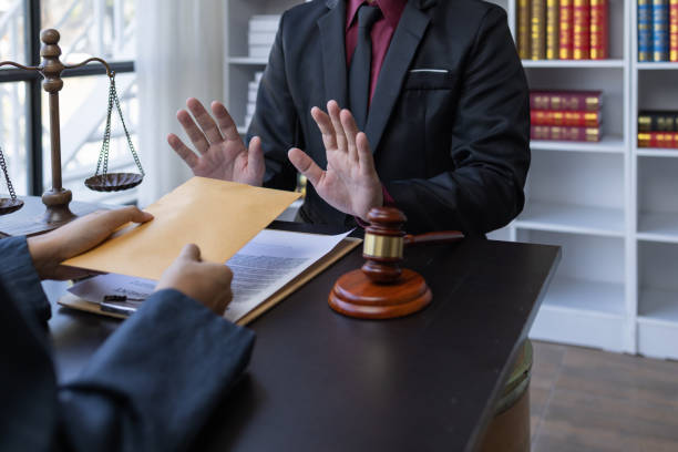 istock Corruption and Bribery,Businessman manager refusing receive money from Business man passing money dollar bills to deal contract.Corruption and anti bribery concept. 1488051100