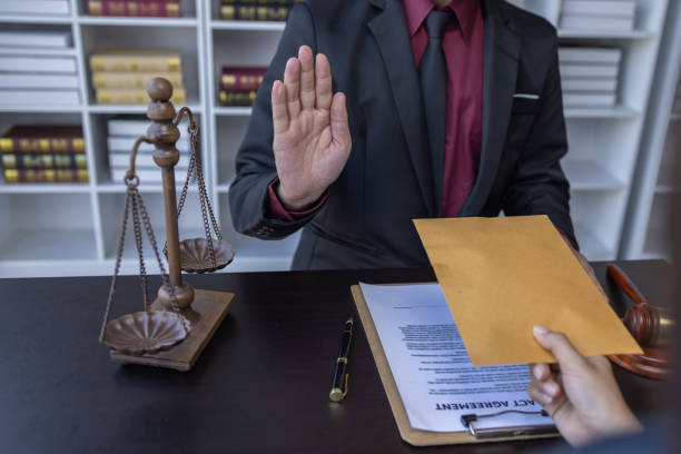 istock Corruption and Bribery,Businessman manager refusing receive money from Business man passing money dollar bills to deal contract.Corruption and anti bribery concept. 1488051132