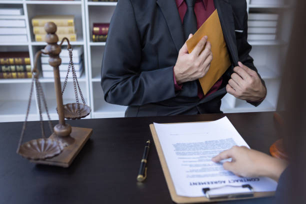 istock Corruption and Bribery,Businessman manager refusing receive money from Business man passing money dollar bills to deal contract.Corruption and anti bribery concept. 1488051148
