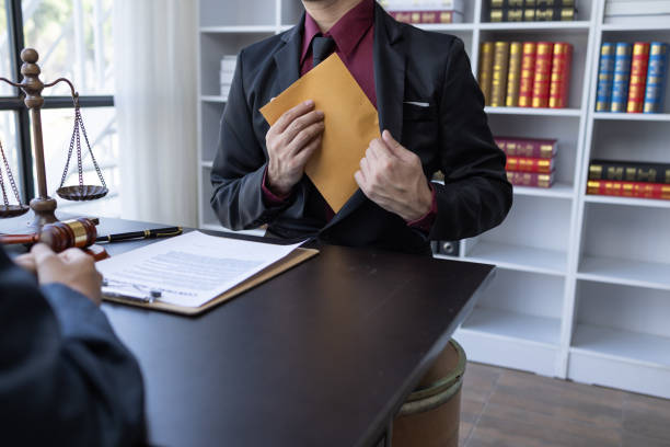 istock Corruption and Bribery,Businessman manager refusing receive money from Business man passing money dollar bills to deal contract.Corruption and anti bribery concept. 1488051150