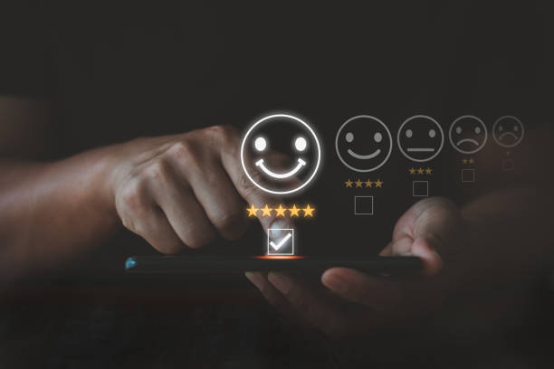 istock Customer hand using smartphone for review satisfaction survey online application to give excellent five star rating and smile face icon in service, feedback for service providers to improve business. 1488055142