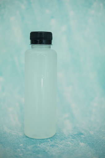 Bottle of coconut water juice on a blue background