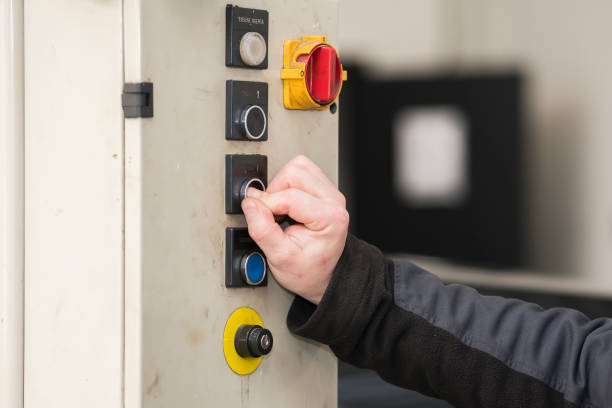 istock Selective focus. Detailed view of an arm and hand from a blue-collar working pushing on a button from a hydrolic car lift. car service, repair, maintenance concept. 1488061719