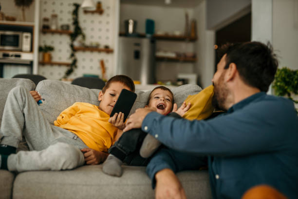 istock Father spending time with kids at home and telling them not to use a mobile phone that much. 1488069538