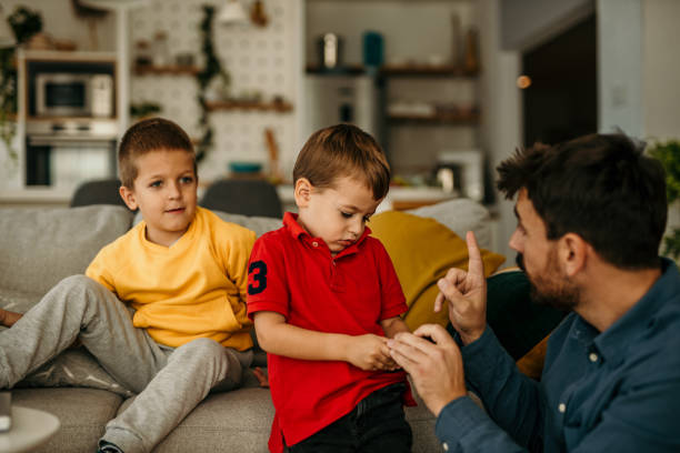 istock Father spending time with kids at home and telling them not to use a mobile phone that much. 1488069609