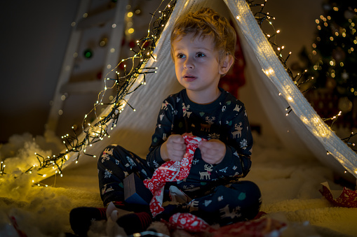 Magic tent with garland home, boy inside