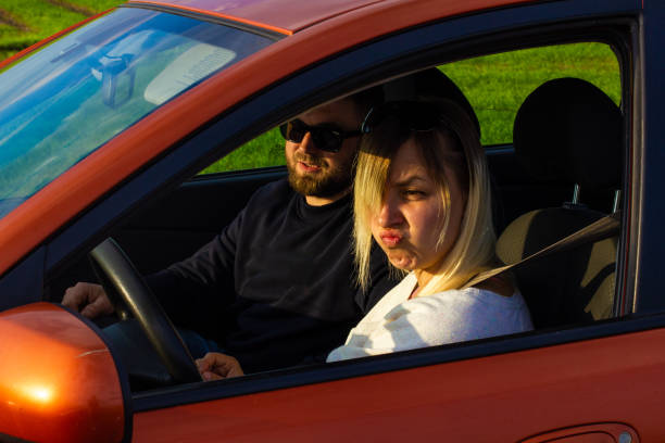 istock A lovely woman makes a funny face as she turns away from the climbing instructor. While the driving instructor explains the theory, the woman turns away and makes funny faces. 1488070627