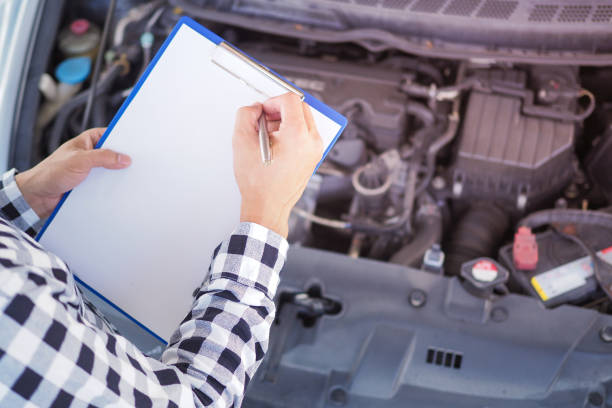 istock The mechanic is checking the condition. Write down the maintenance items on the clipboard. 1488070911