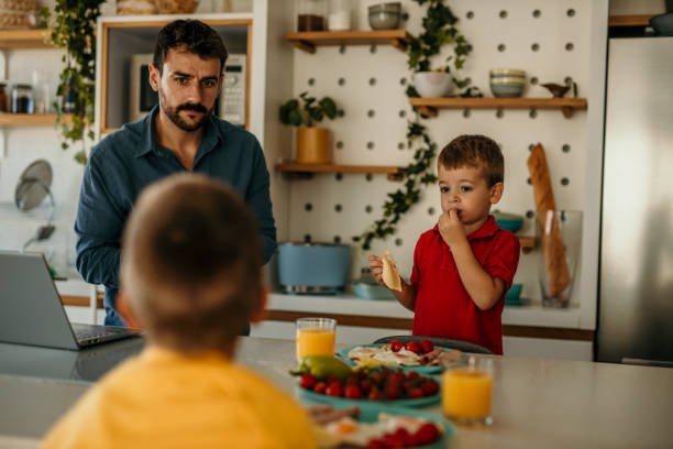 istock Father and his two boys cook and eat breakfast together 1488071059