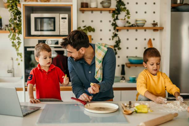 istock Father and his two boys cook and eat breakfast together 1488071146
