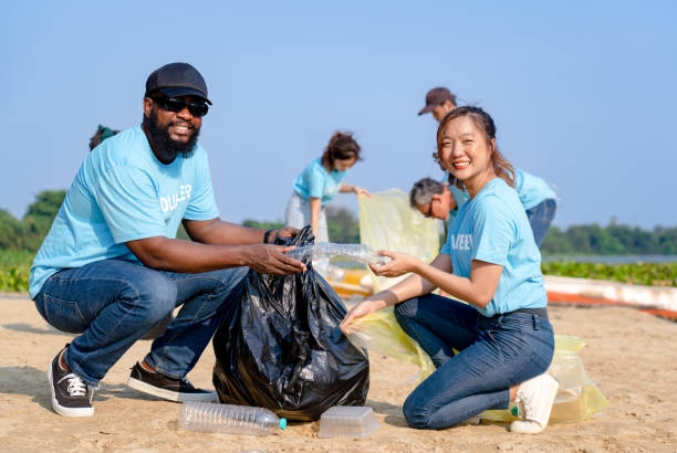 istock teamwork young diverse friends happy to clean up river beach together 1488071836