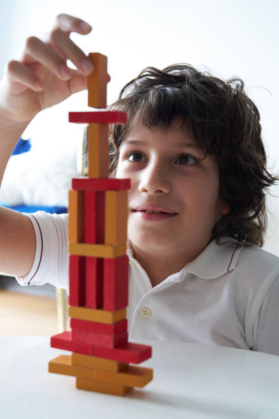 istock Cute Little Boy Playing with wooden block 1488071950