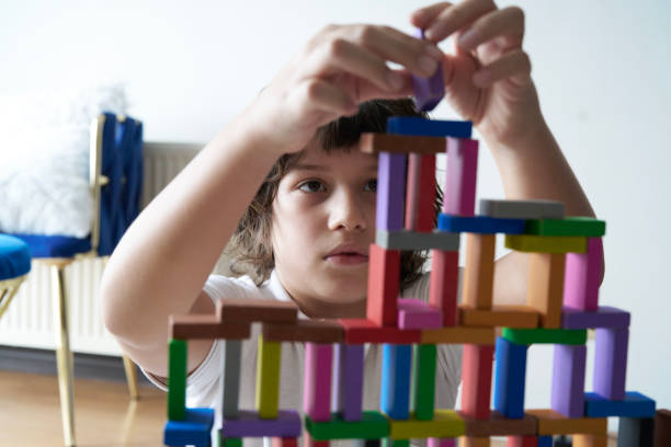 istock Cute Little Boy Playing with wooden block 1488072045