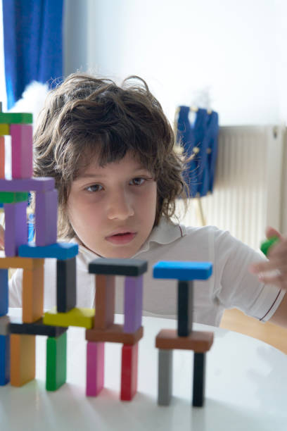 istock Cute Little Boy Playing with wooden block 1488072074
