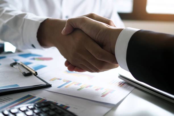 istock Two executives handshake as partners after the successful meeting. 1488072296
