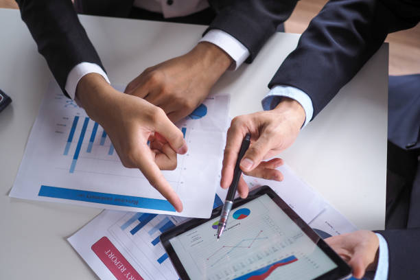 istock Asian consultants analyze and discuss current economic situation. Get financial advice and invest in shares of banks or companies that are in the stock market. 1488073148
