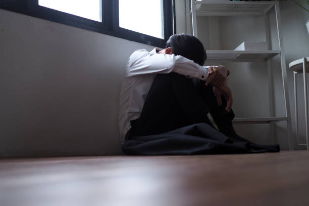 istock Businessmen sitting inside the office alone are stressed. 1488073221