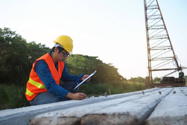 istock Engineers are checking the piles placed in the construction area and the back has cranes. Contractor concept 1488073299