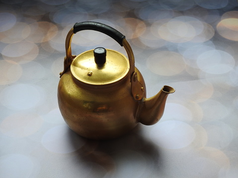 A fancy golden yellow teapot