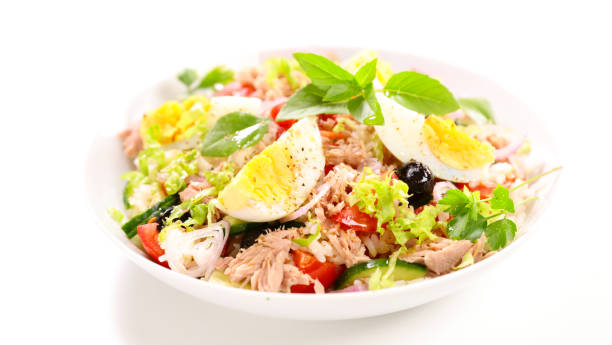 istock mixed rice salad with egg, tunat, tomato and olive on white background 1488074316