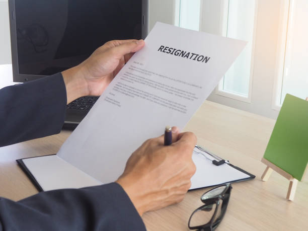 istock Executive sitting on the desk. Read Employee Resignation Letter. Reason for resignation 1488074788
