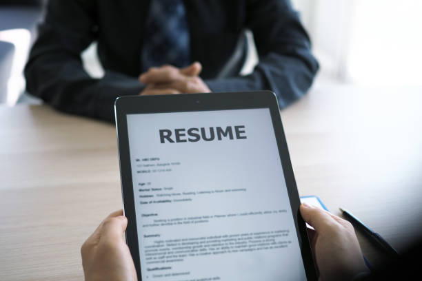 istock Executives are interviewing and watching the resume via tablet. Focus on resume writing tips, applicant qualifications, interview skills and preparation before the interview. 1488075634