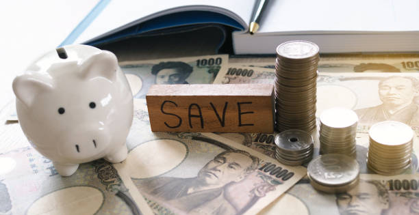 istock Working desk with yen and coins with note book, income and expense. Saving money concept 1488077861