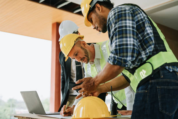 istock multi ethnic engineer brainstorming and measuring for cost estimating on blueprint and floor plan drawings about design architectural and engineering for houses and buildings 1488079930