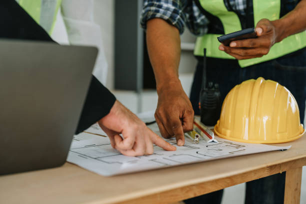 istock multi ethnic engineer brainstorming and measuring for cost estimating on paperworks and floor plan drawings about design architectural and engineering for houses and buildings 1488080017