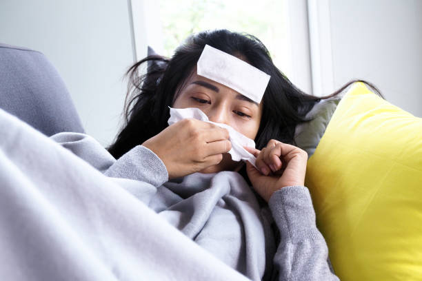 istock Asian women have high fever and runny nose. sick people concept 1488080098