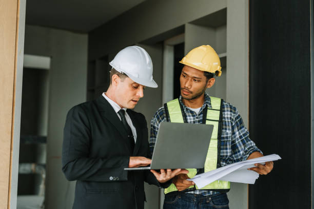 istock multi ethnic engineer brainstorming and measuring for cost estimating on blueprint and floor plan drawings about design architectural and engineering for houses and buildings 1488080771