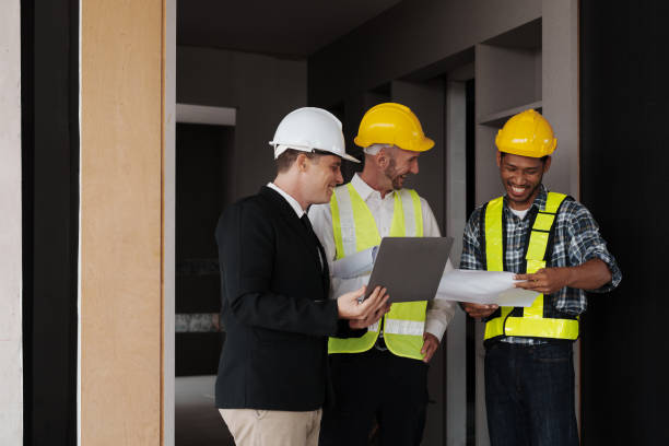istock multi ethnic engineer brainstorming and measuring for cost estimating on blueprint and floor plan drawings about design architectural and engineering for houses and buildings 1488080852